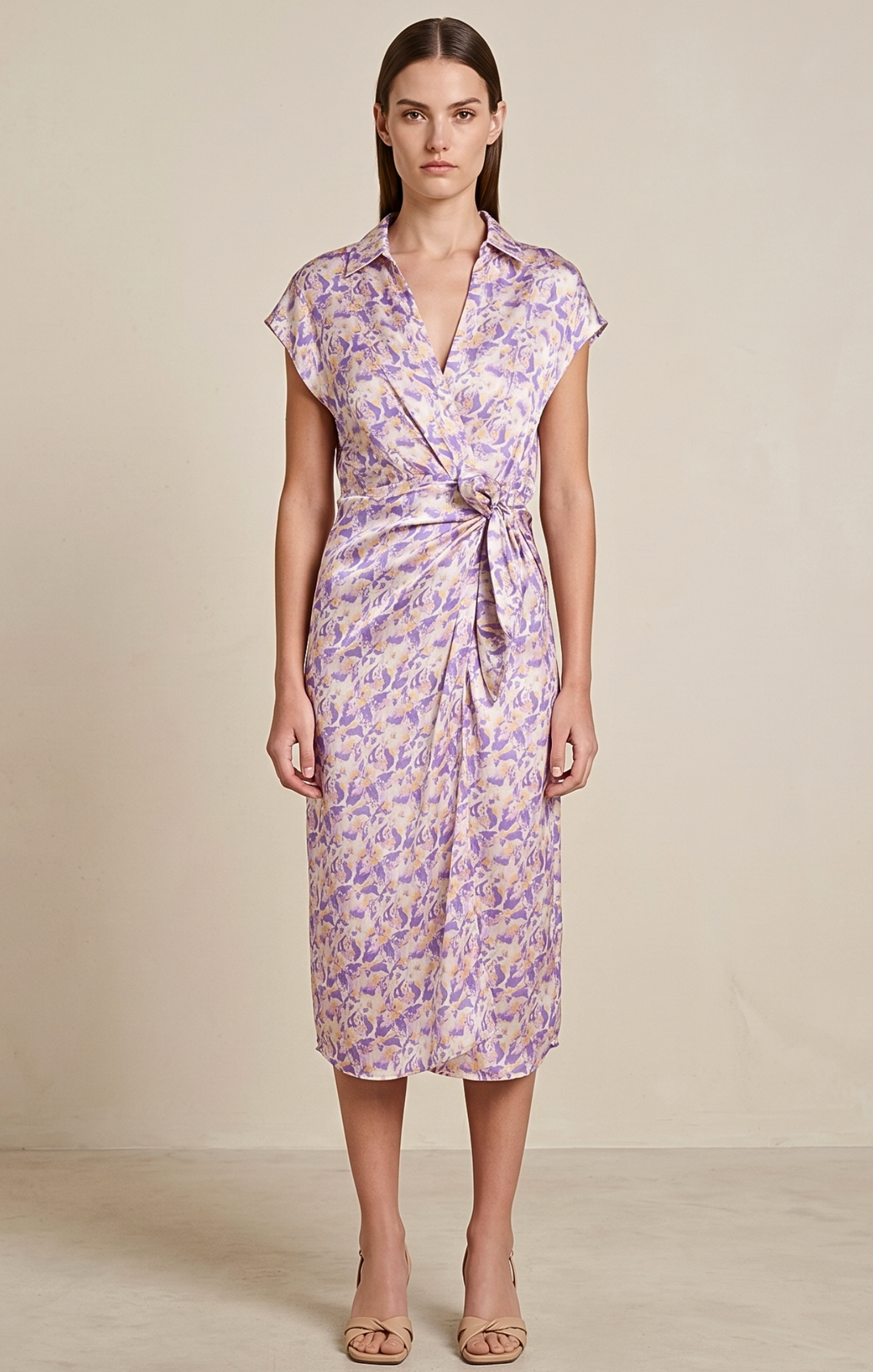 Woman wearing a floral dress against a plain background