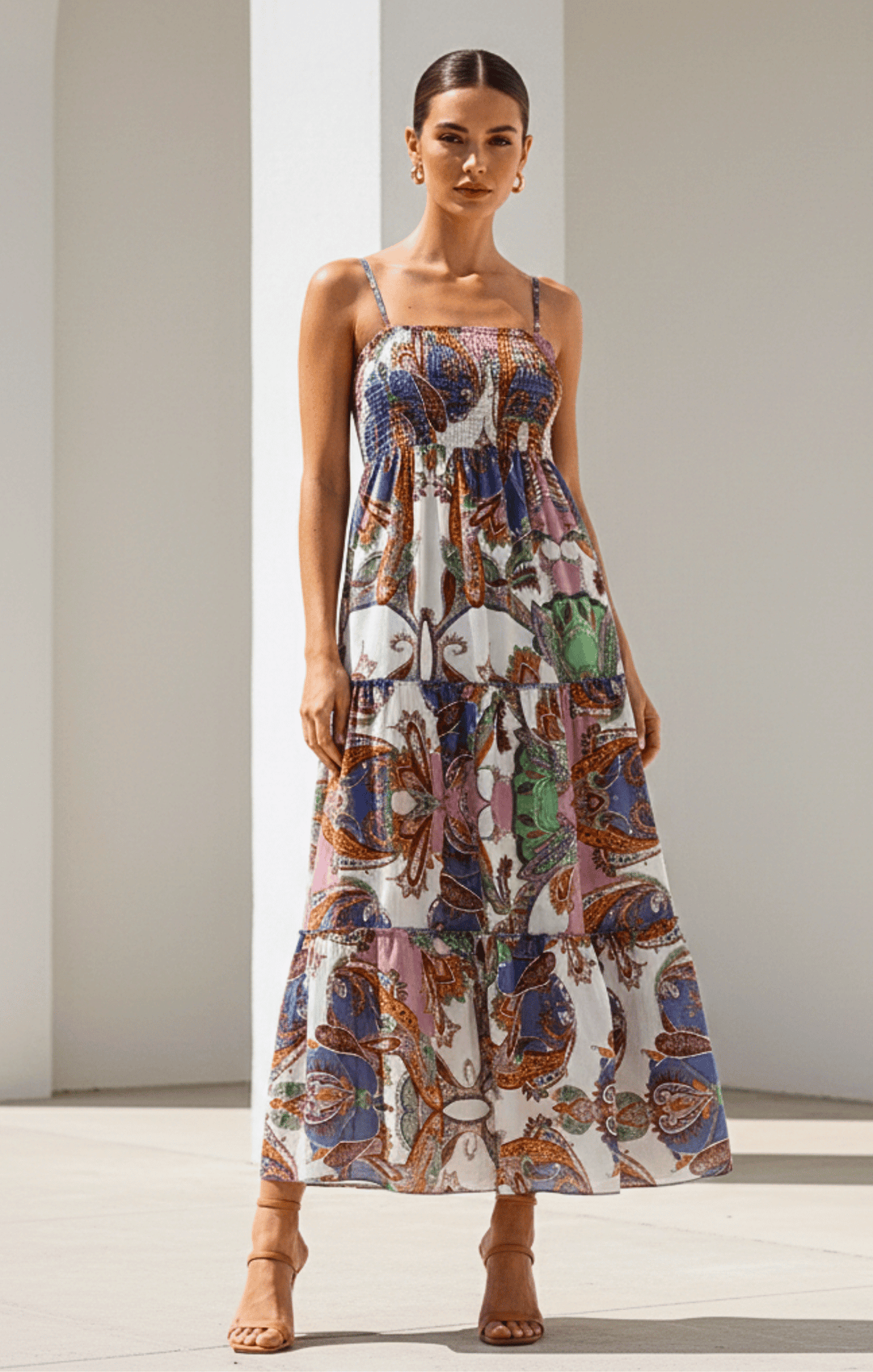 Woman wearing a colorful patterned dress against a neutral background