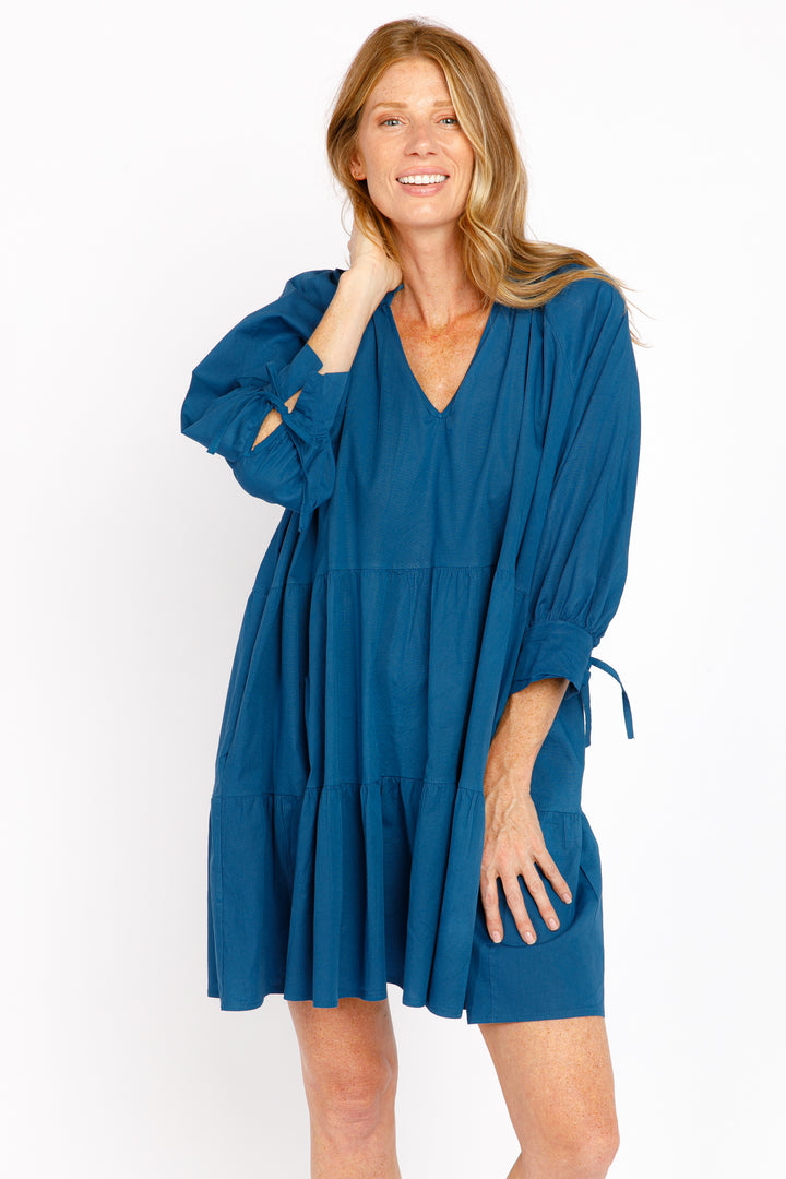 Woman wearing a blue dress on a white background