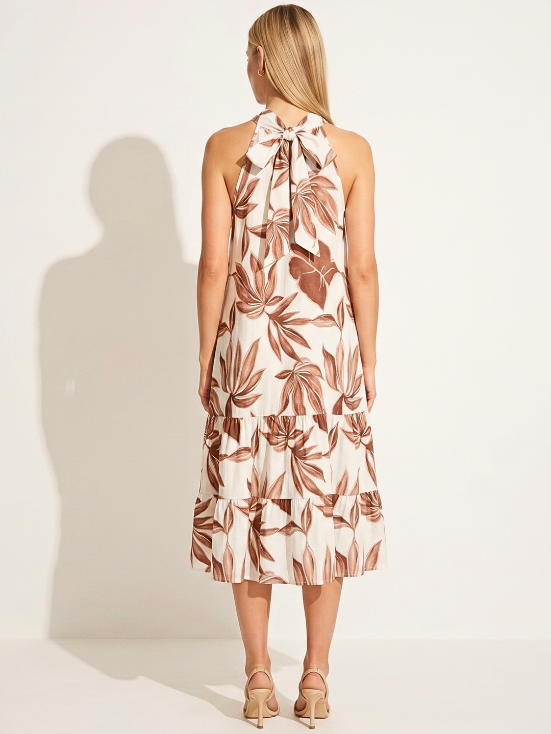 Woman wearing a floral dress against a white background