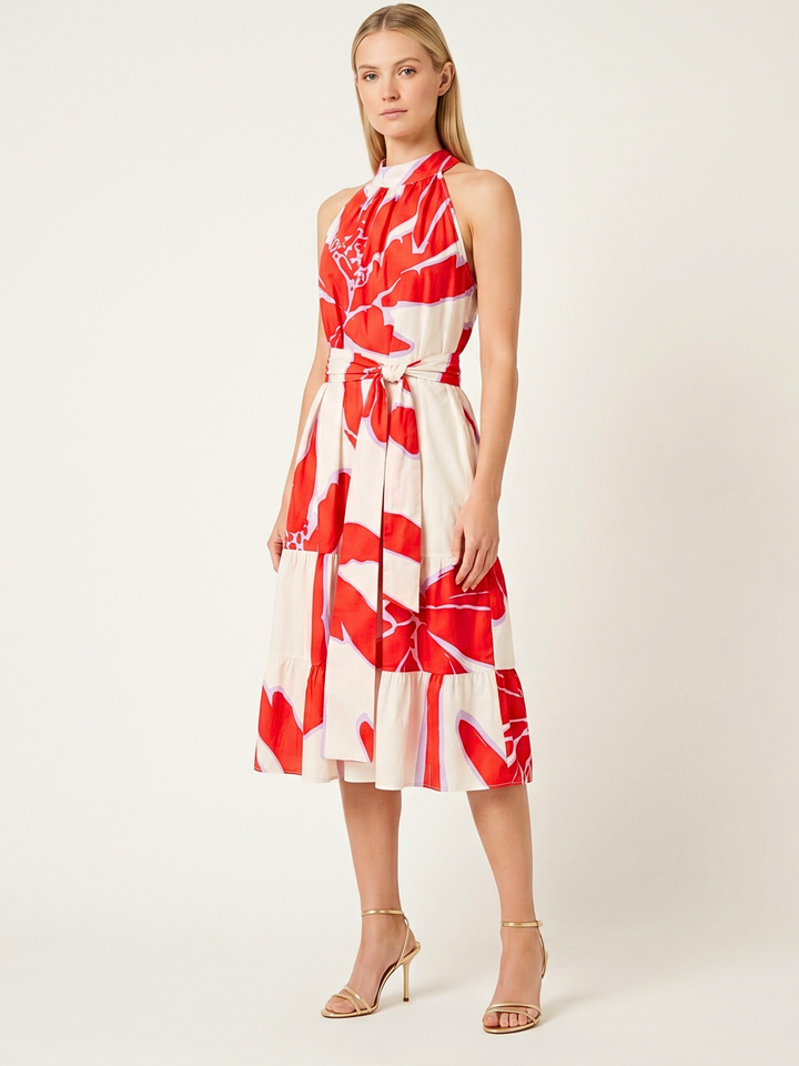 Woman wearing a red and white floral dress on a white background