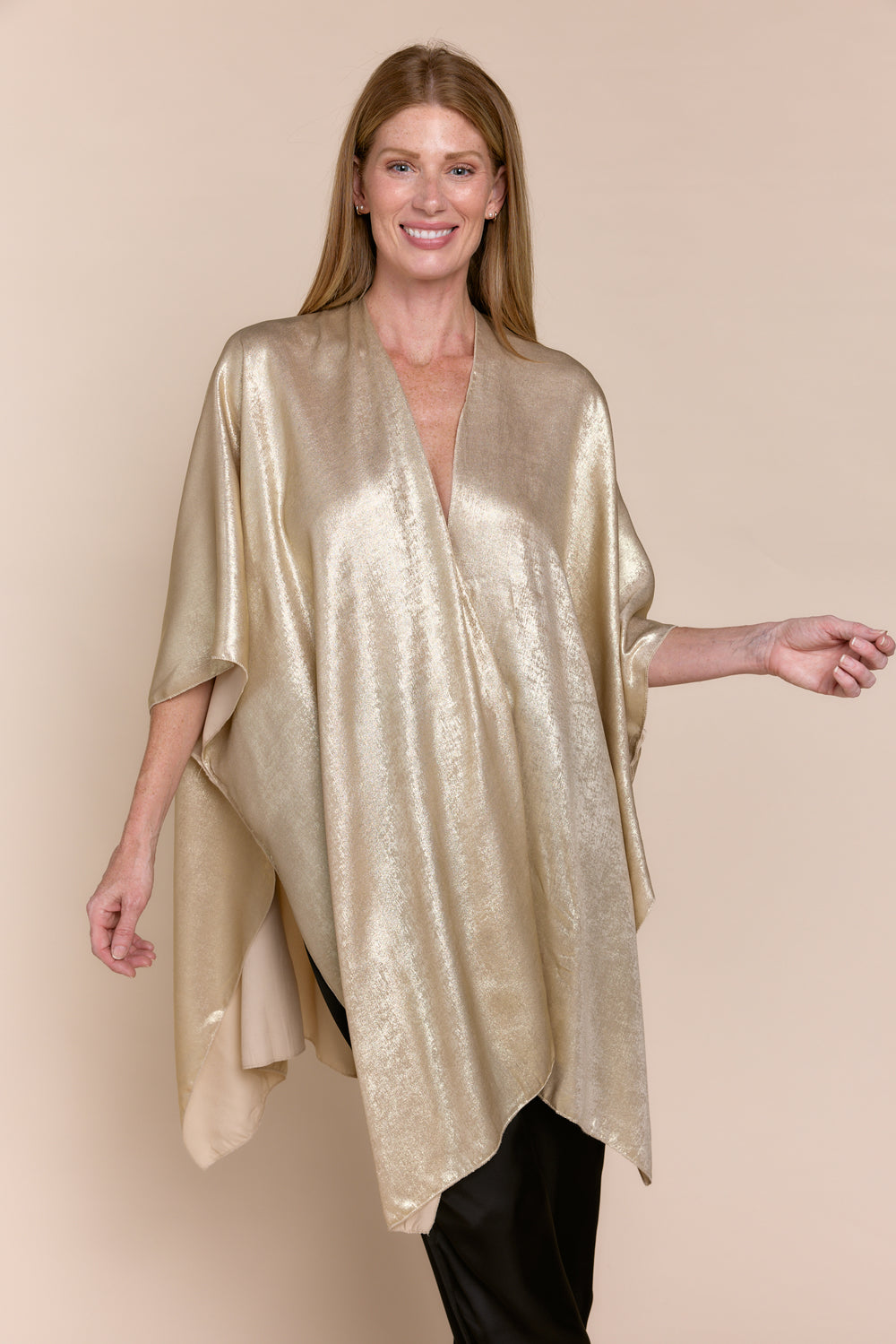 Metallic gold kimono jacket with an open front and asymmetrical hem, styled over a black silk camisole and wide-leg trousers.