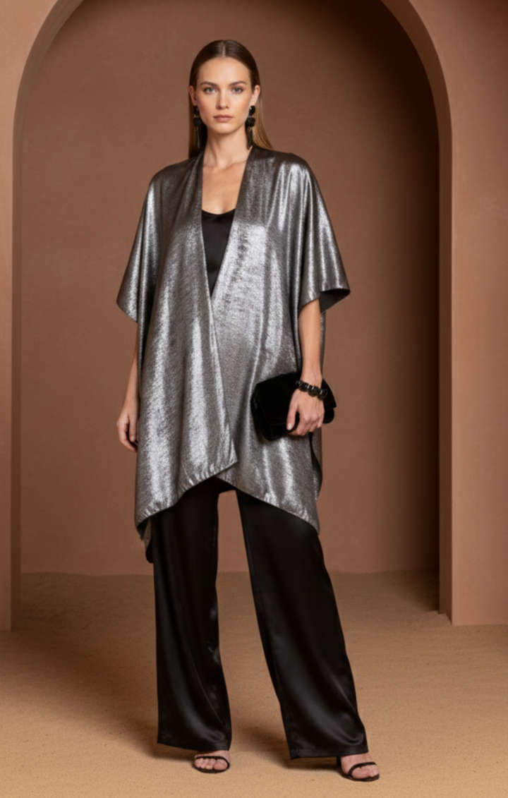 Metallic gold kimono jacket with an open front and asymmetrical hem, styled over a black silk camisole and wide-leg trousers.