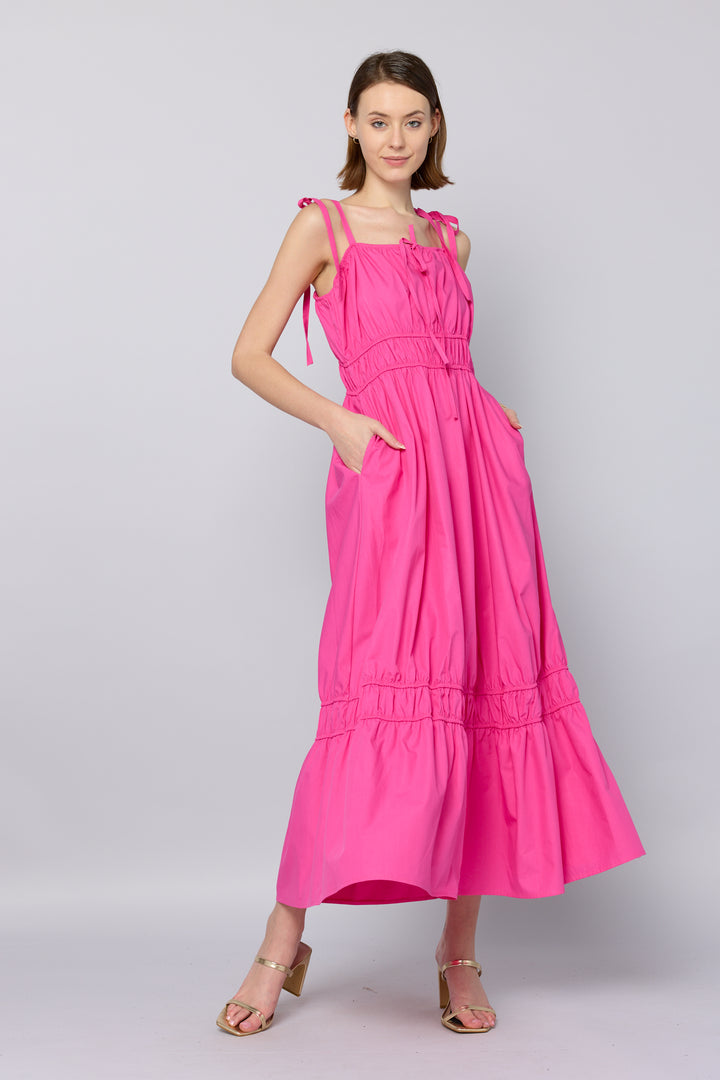 Woman wearing a pink dress on a light gray background