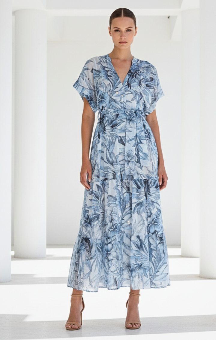 Woman wearing a blue floral dress against a white background