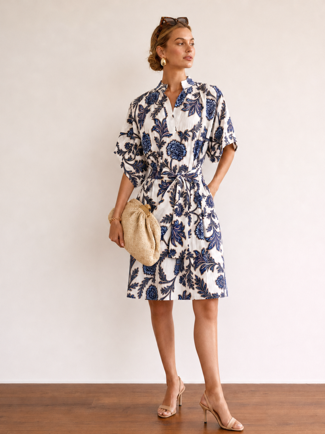 Woman wearing a floral dress with a plain background
