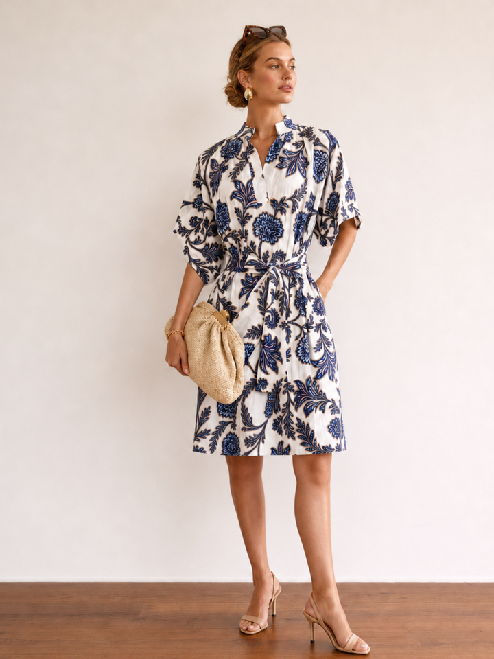 Woman wearing a floral dress with a plain background