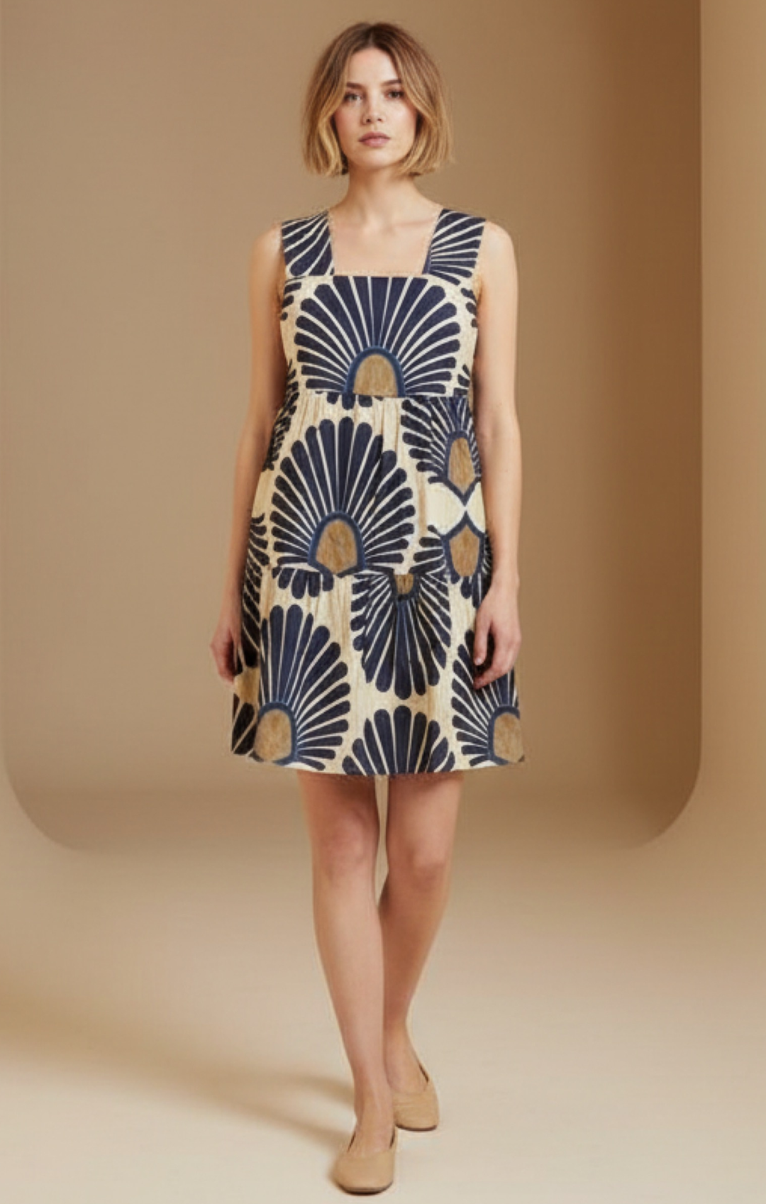 Woman wearing a sleeveless dress with a geometric pattern on a beige background