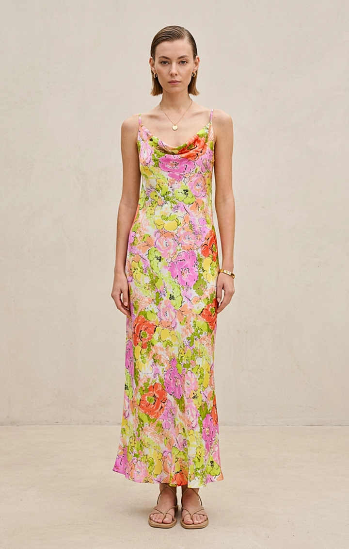 Woman wearing a floral dress against a plain background