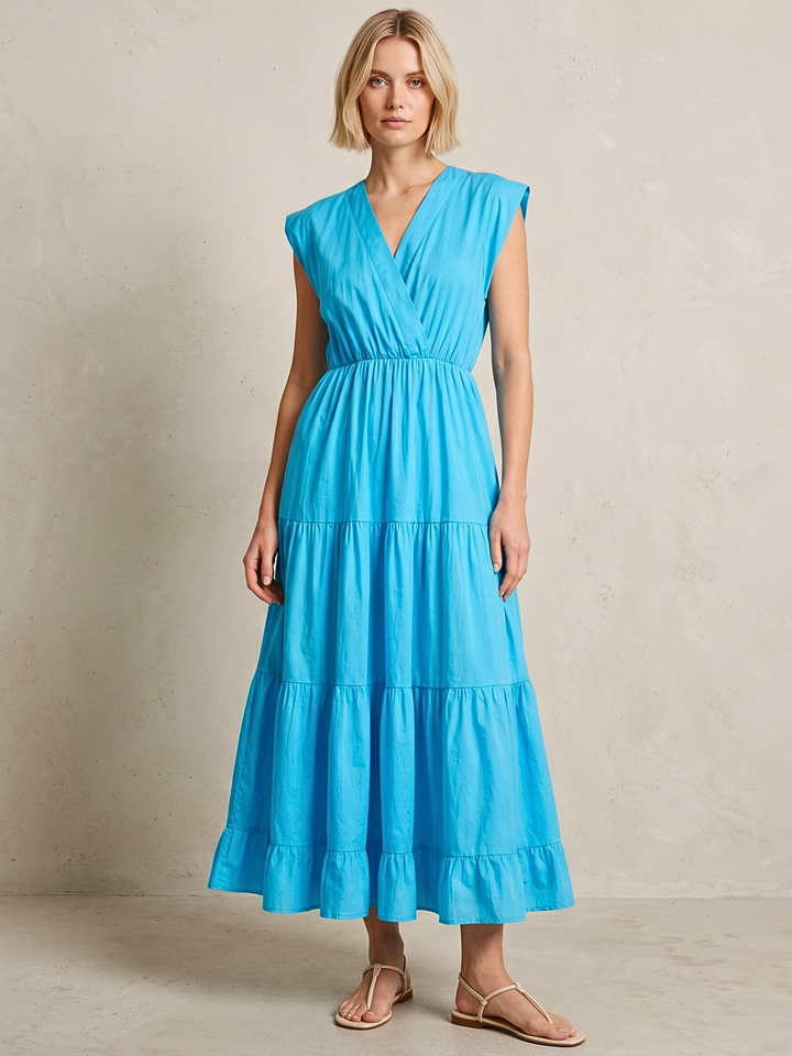 Woman wearing a blue dress against a neutral background