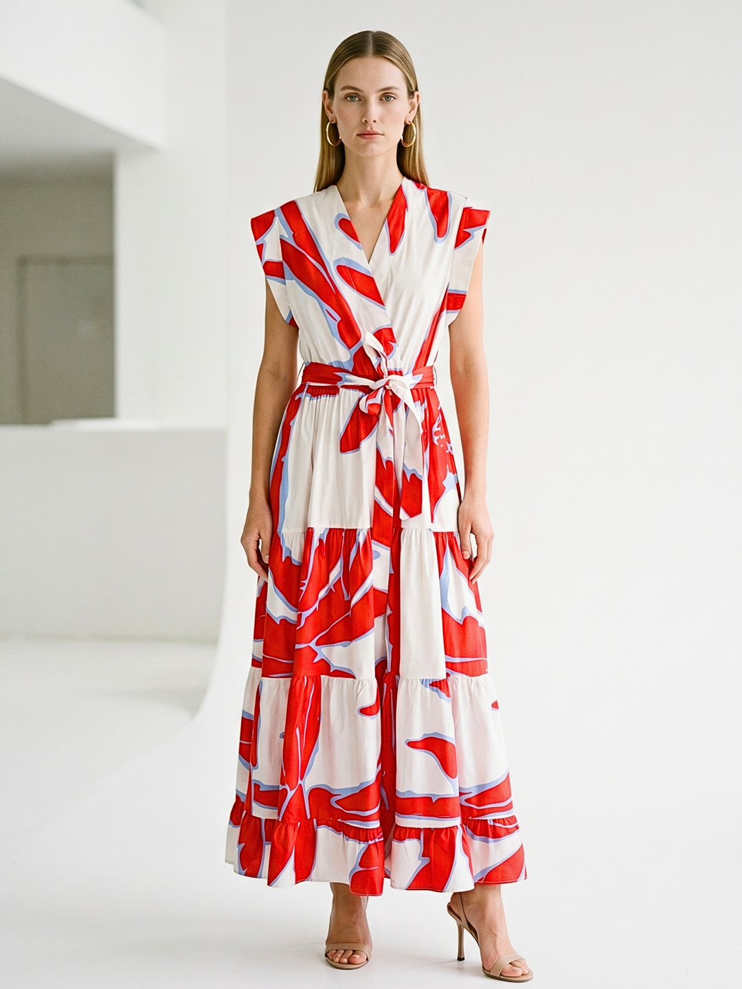 Woman wearing a red and white patterned dress in a minimalistic setting