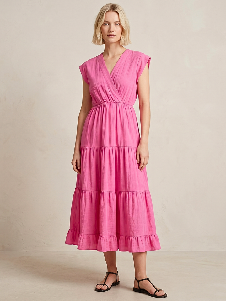 Woman wearing a pink dress against a beige background