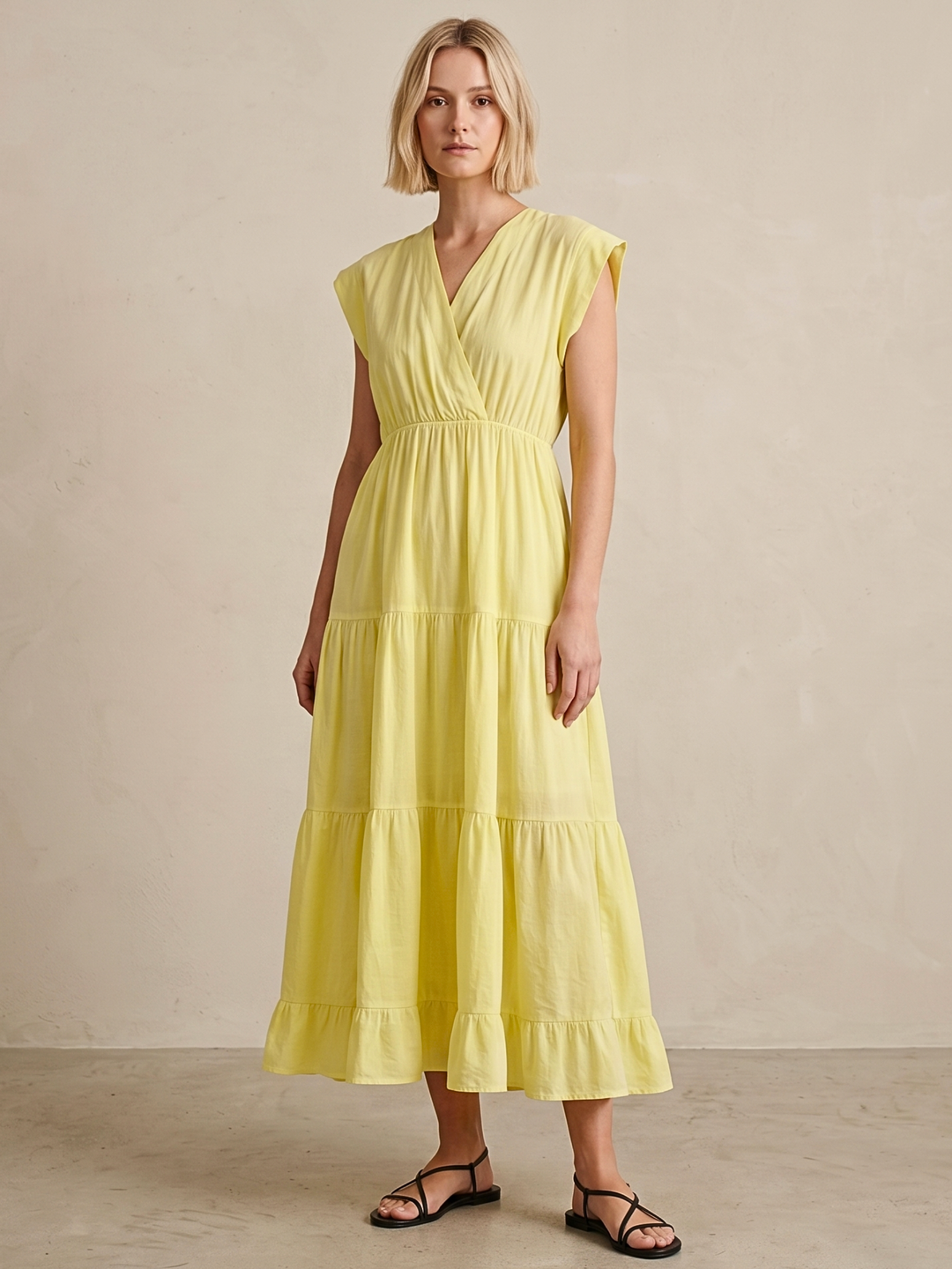 Woman wearing a yellow dress against a beige background