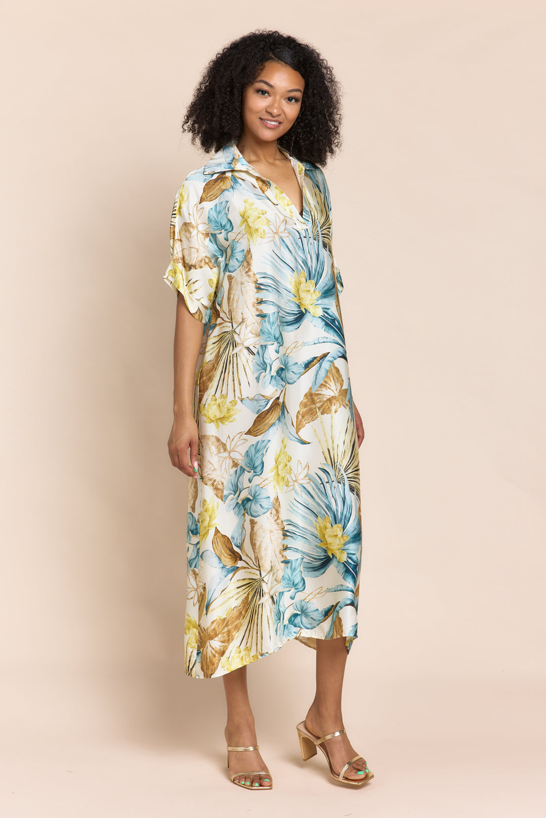Woman wearing a floral dress against a beige background