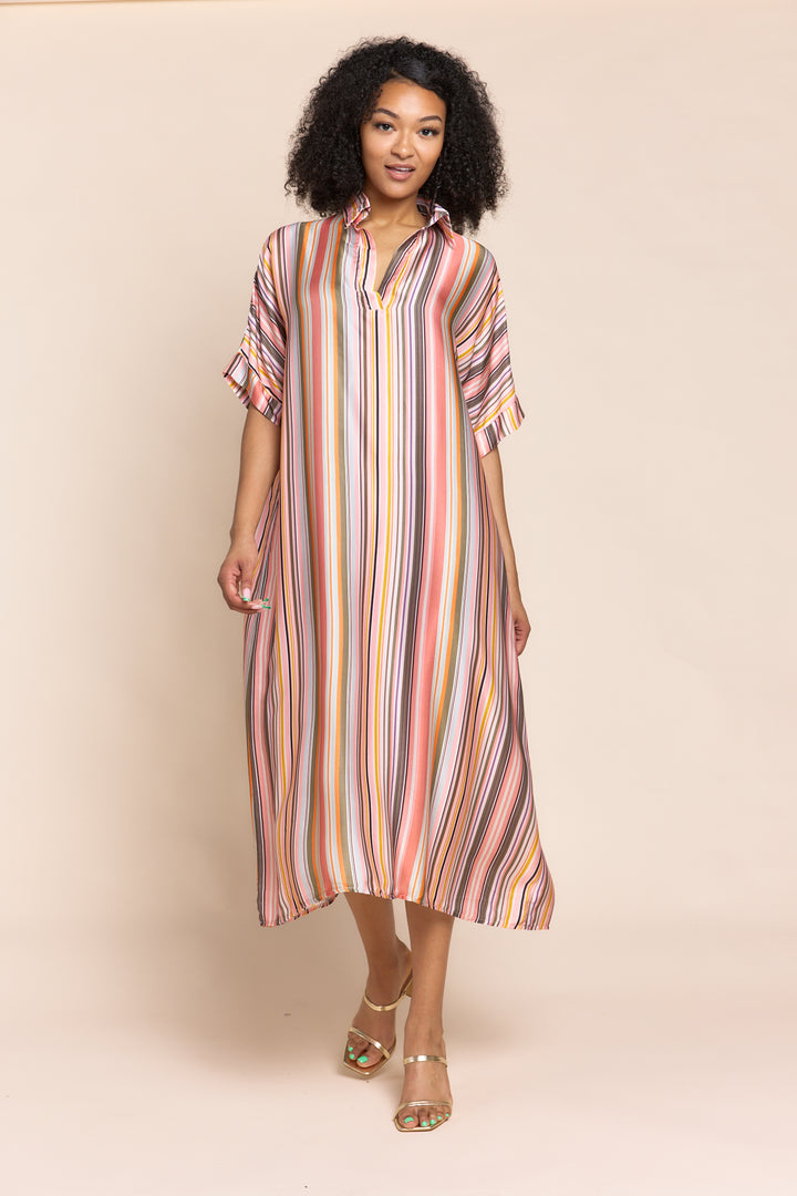 Woman wearing a striped dress against a beige background