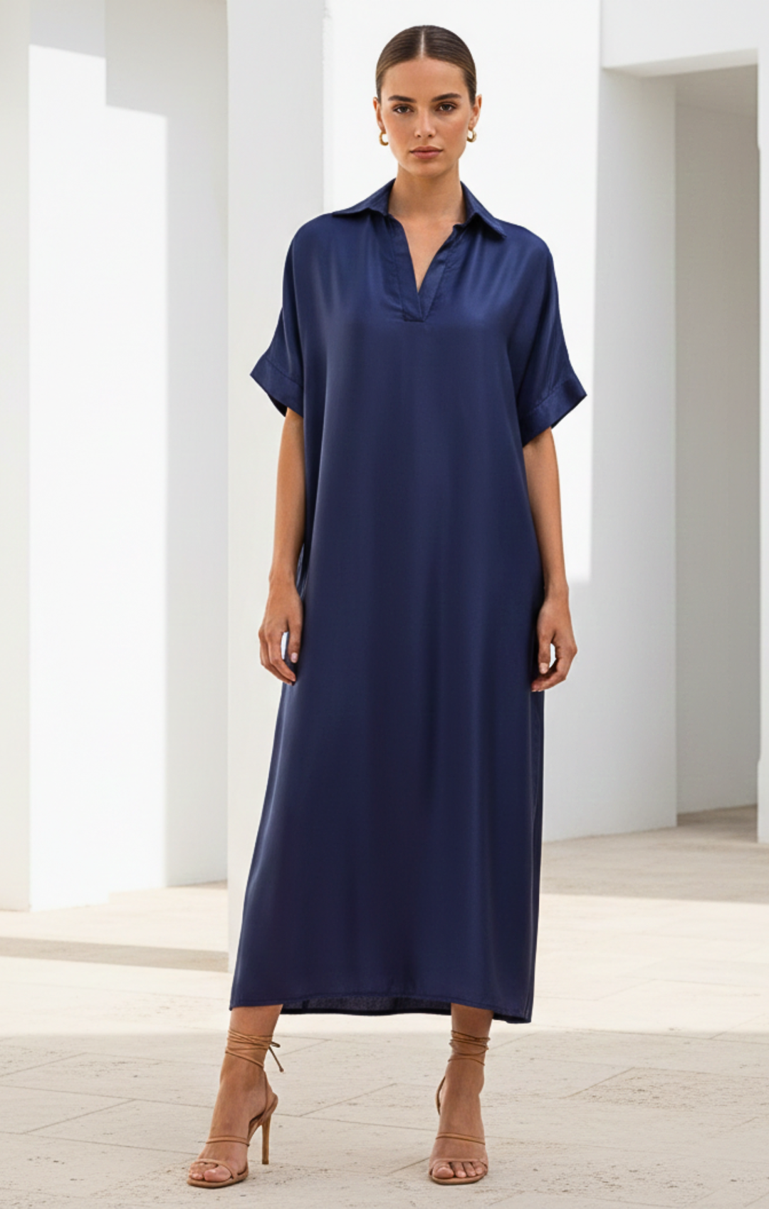 Woman wearing a blue dress in a minimalistic setting