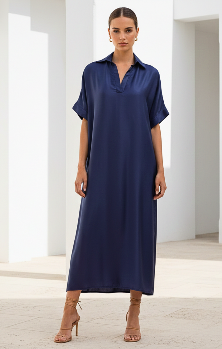 Woman wearing a blue dress in a minimalistic setting