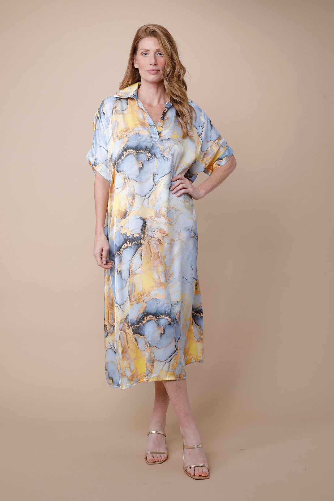 Woman wearing a floral dress against a beige background